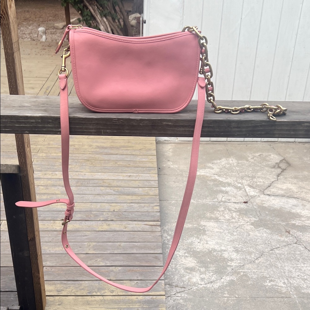 Coach pink handbag with leather and gold colored hardware